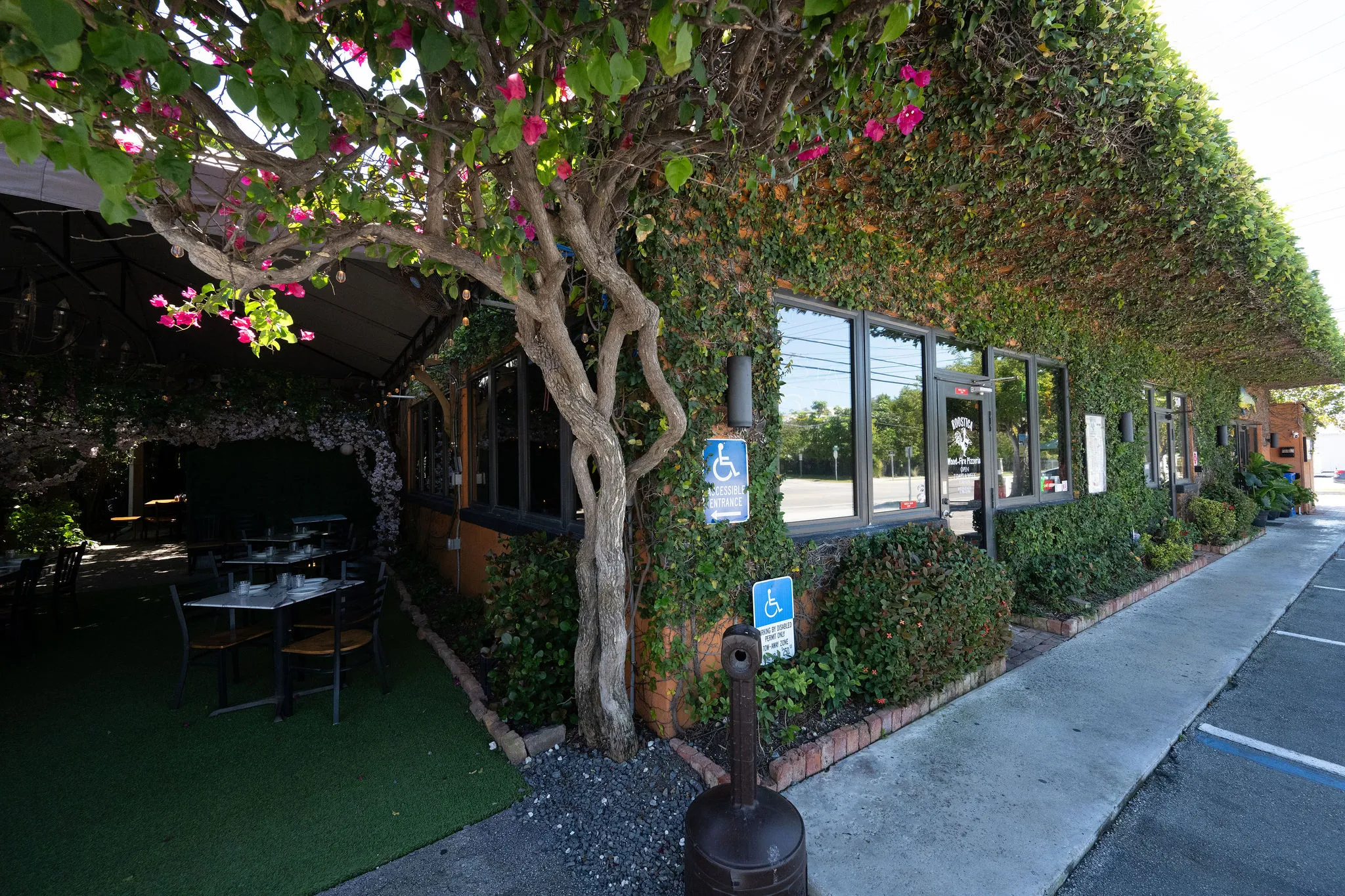 Roostica Wood-Fire Pizzeria exterior with patio seating