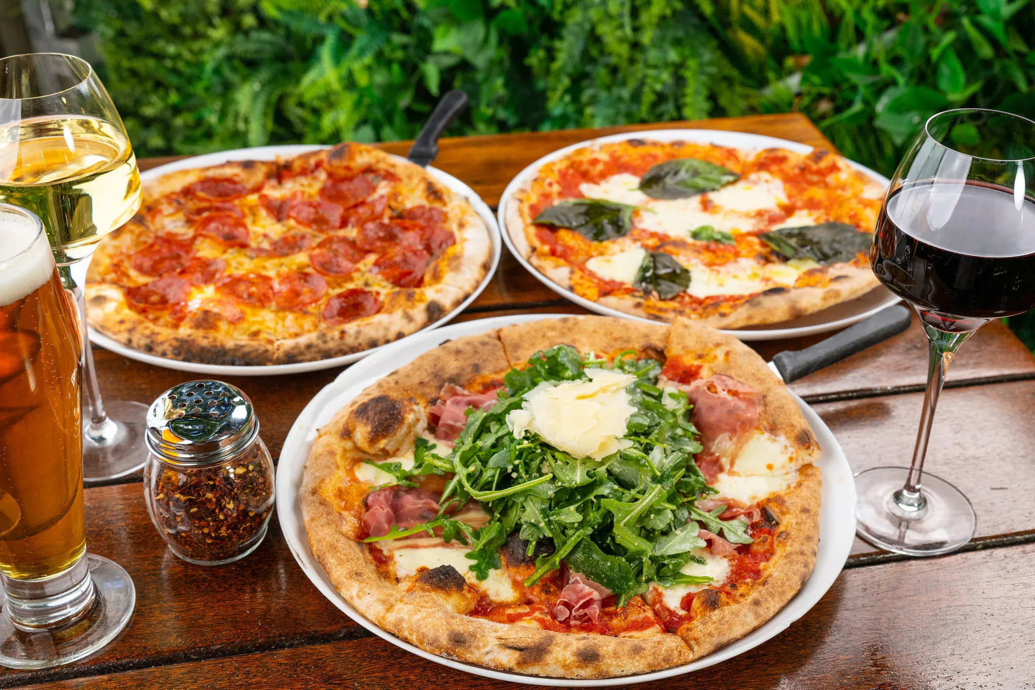A spread of Roostica wood-fired pizzas